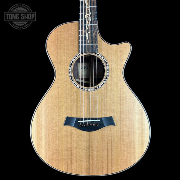 Acoustic guitar with a visible brand logo on a black background