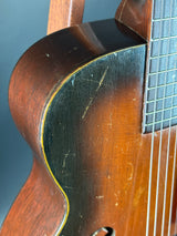 Close-up of a wooden acoustic guitar's soundhole and neck