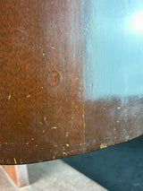 Close-up of a wooden surface with visible scratches and wear.