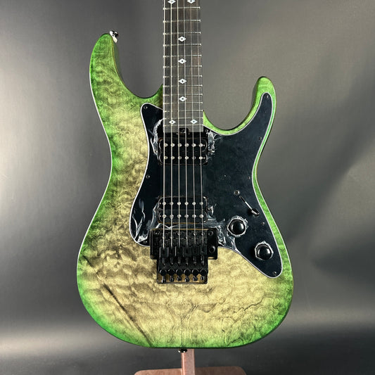 Green electric guitar on a gray background