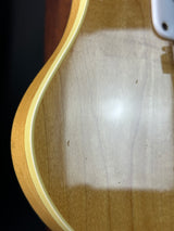 Close-up of a guitar's soundhole with a white patch