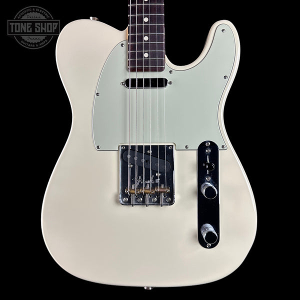 A classic Fender Telecaster-style electric guitar body in cream/off-white, featuring a light greenish-white pickguard, black hardware, and a dark fretboard, shown against a solid black background with a Tone Shop watermark in the top left.