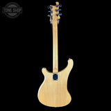 Back view of a guitar with 'Tone Shop' logo in the corner