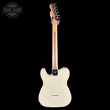 A classic Fender Telecaster electric guitar shown from the back, featuring a cream-colored body, a natural maple neck, and chrome hardware, set against a solid black background with a Tone Shop watermark in the top left corner.