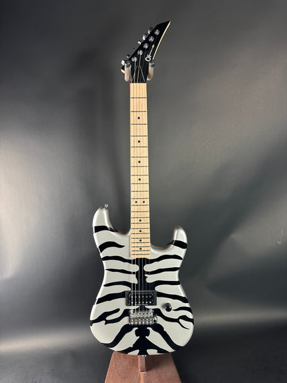 Electric guitar with zebra pattern on a gray background