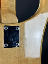 Close-up of a wooden axe handle with a metal plate and screws.