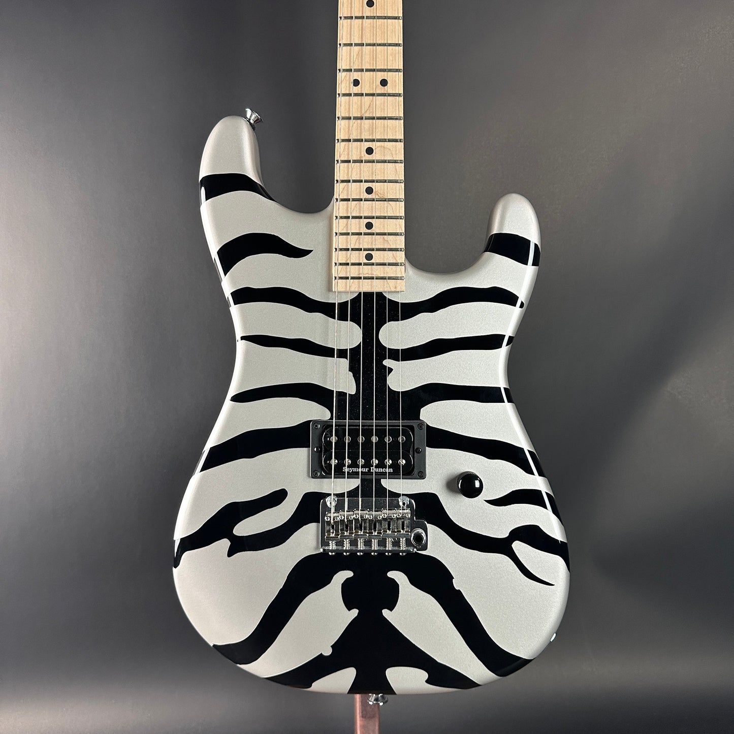 Guitar with zebra pattern on a gray background