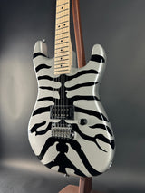 Electric guitar with zebra pattern on a dark background