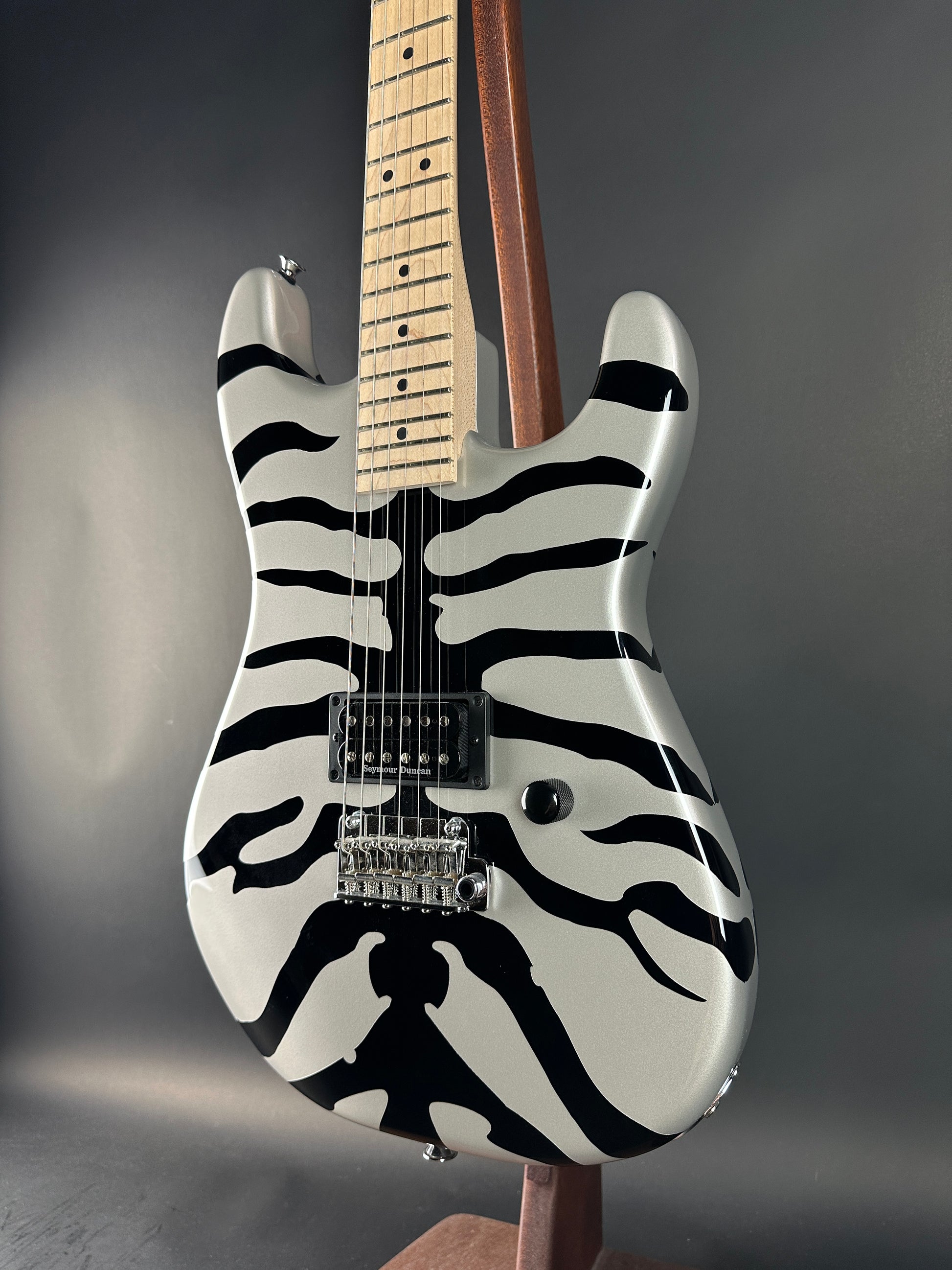 Electric guitar with zebra pattern on a dark background