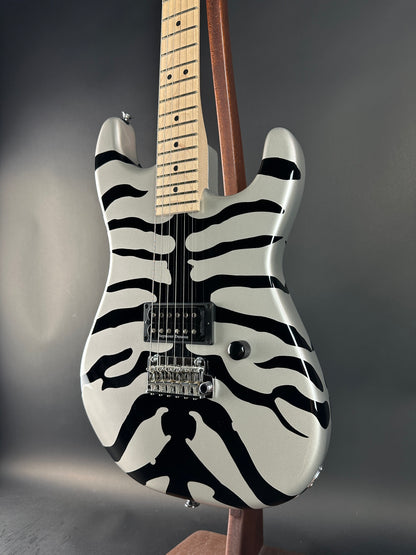 Electric guitar with zebra pattern on a dark background