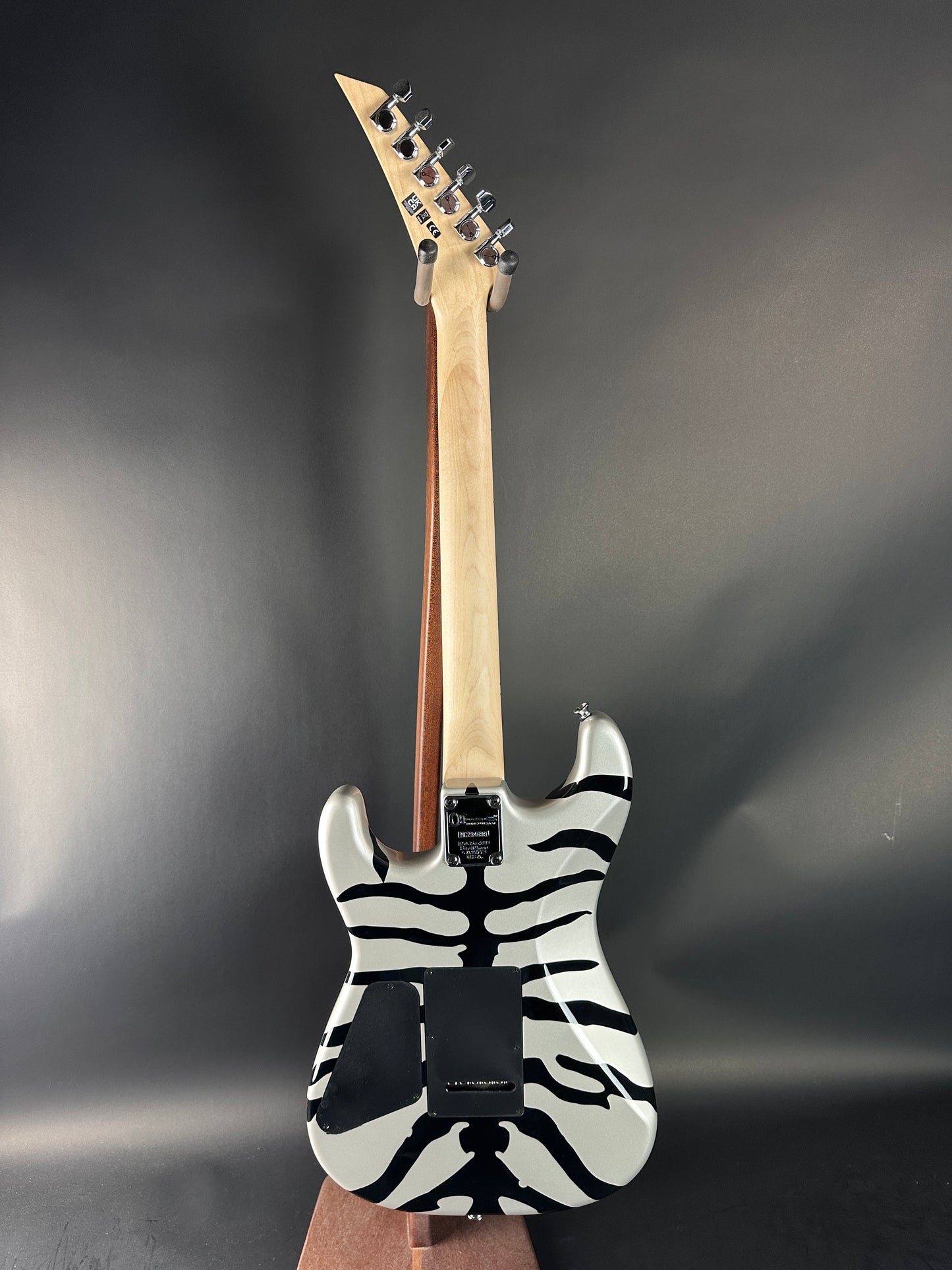Electric guitar with zebra pattern body on a dark background