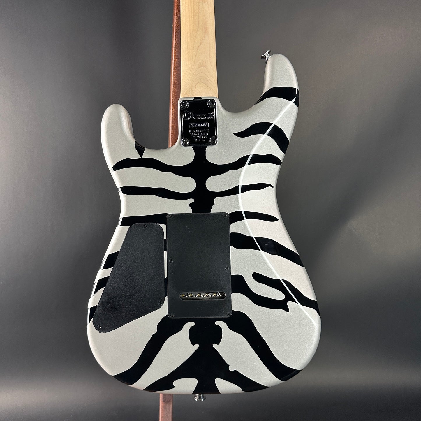 Electric guitar with zebra pattern on a gray background