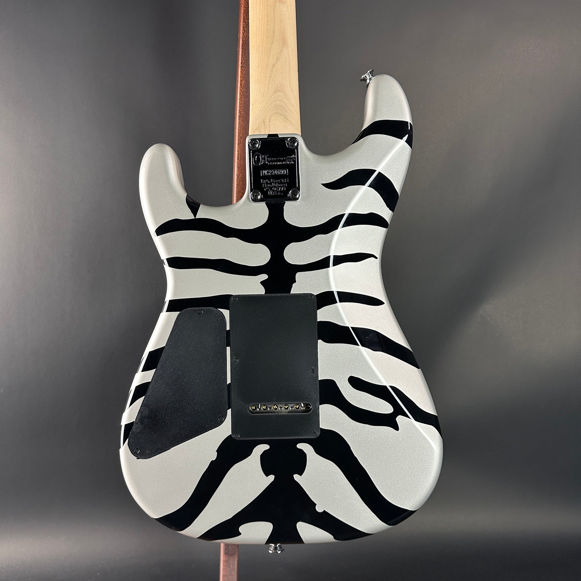 Electric guitar with zebra pattern on a gray background