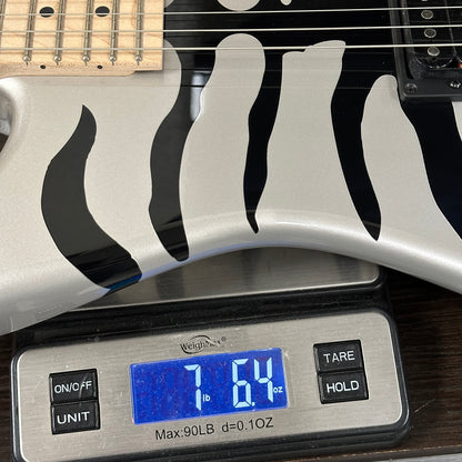 Guitar on a digital scale displaying weight