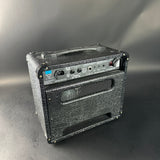 Black guitar amplifier on a gray background