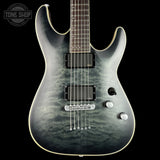 Electric guitar with a black and gray pattern on a black background, featuring the Tone Shop logo.