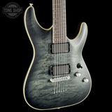 Electric guitar with a black and gray pattern on a black background, featuring the Tone Shop logo.