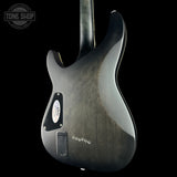 Back view of a guitar with a dark finish on a black background, featuring the Tone Shop logo.