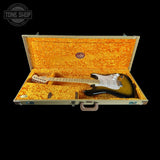 Electric guitar in a case with a visible brand logo on a black background