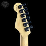 Guitar headstock with Fender tuners on a black background