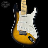 Electric guitar with a sunburst finish on a black background, featuring the Tone Shop logo.