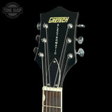 Close-up of a Gretsch Electromatic electric guitar headstock and upper neck against a black background, with Gretsch branding in yellow and white.