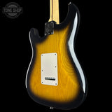 Electric guitar with a sunburst finish on a black background, featuring the Tone Shop logo.