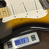 Electric guitar on a digital scale displaying weight