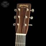 Guitar headstock with Martin & Co logo on a black background