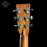 Guitar headstock with tuning pegs on a black background, featuring 'Tone Shop' logo.