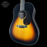 Acoustic guitar with a sunburst finish on a black background, featuring the Tone Shop logo.