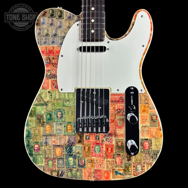 A custom electric guitar with a white pickguard and black hardware, decorated with a vintage postage stamp collage pattern in various colors. The brand 'Tone Shop' is visible as a watermark in the top left corner.