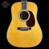 Acoustic guitar with a visible brand logo in the corner