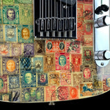 Close-up of an electric guitar body featuring a vintage postage stamp collage design in muted red, green, blue, and beige tones, with a black bridge and chrome controls visible.
