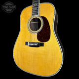 Acoustic guitar with a visible brand logo in the corner