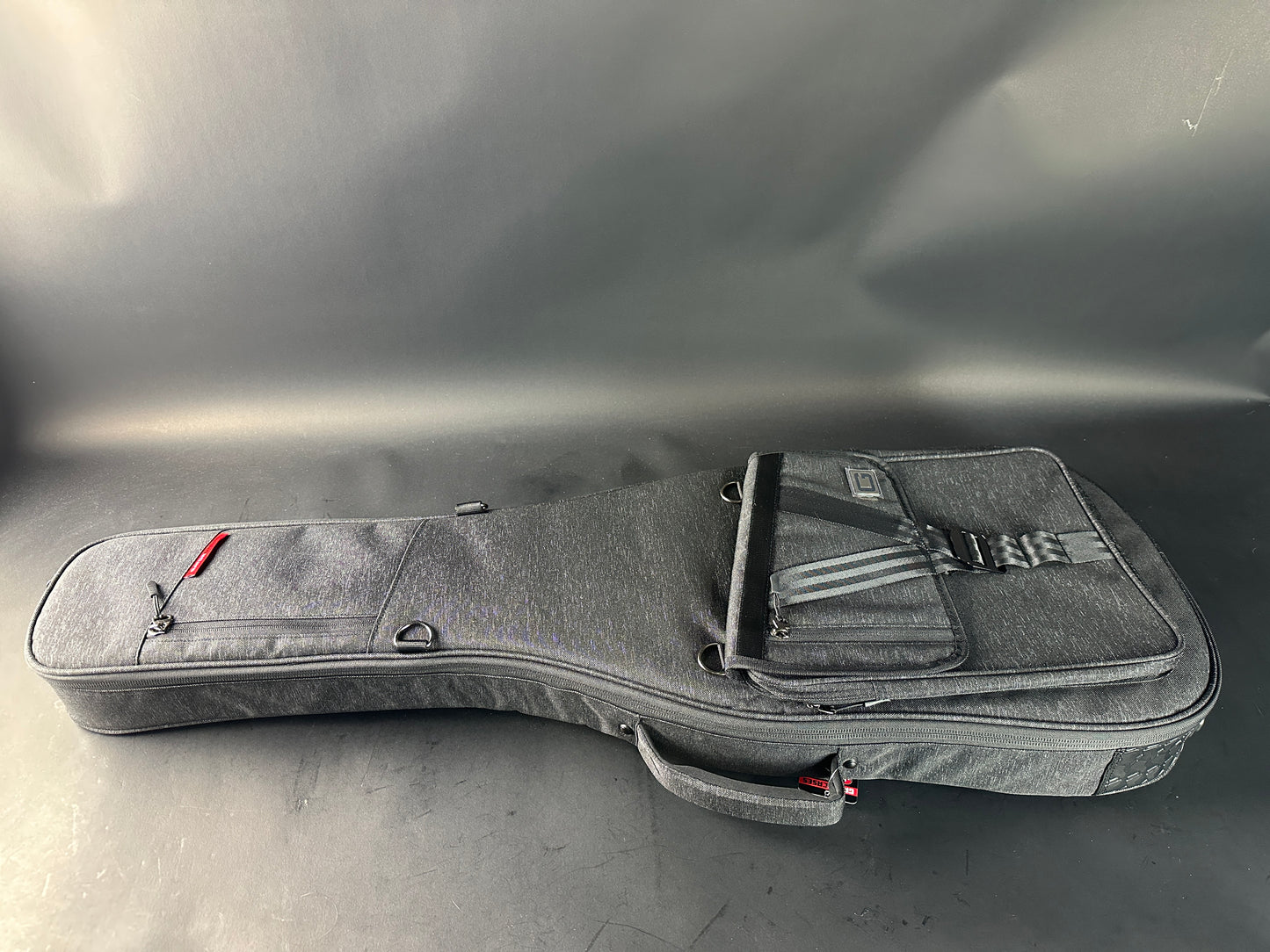 Gray guitar case on a reflective surface