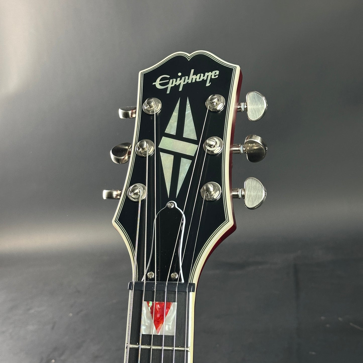 Epiphone guitar headstock on a dark background