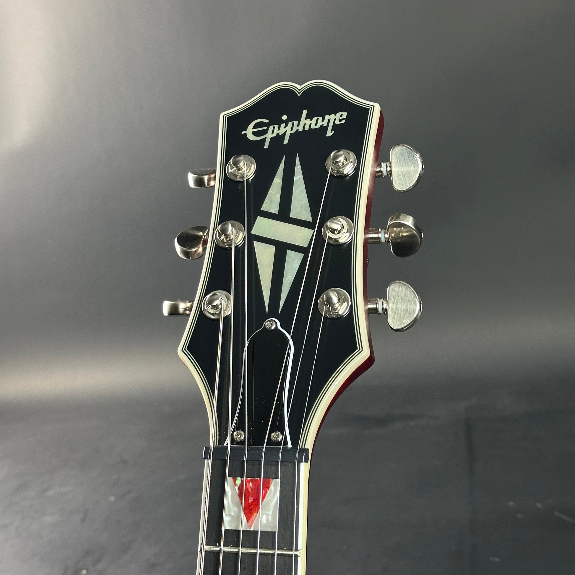 Epiphone guitar headstock on a dark background
