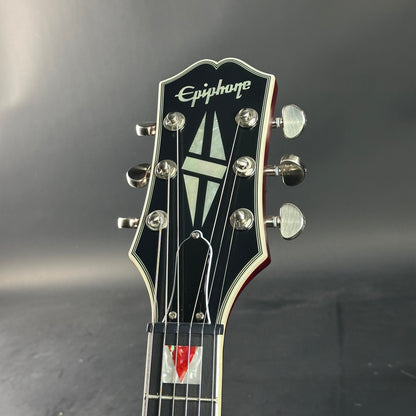 Epiphone guitar headstock on a dark background