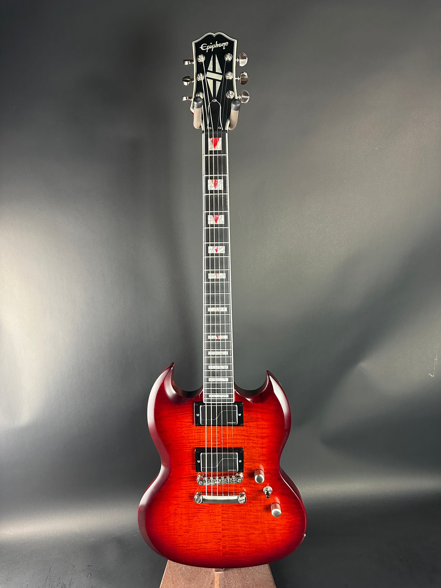 Electric guitar with a sunburst finish on a gray background