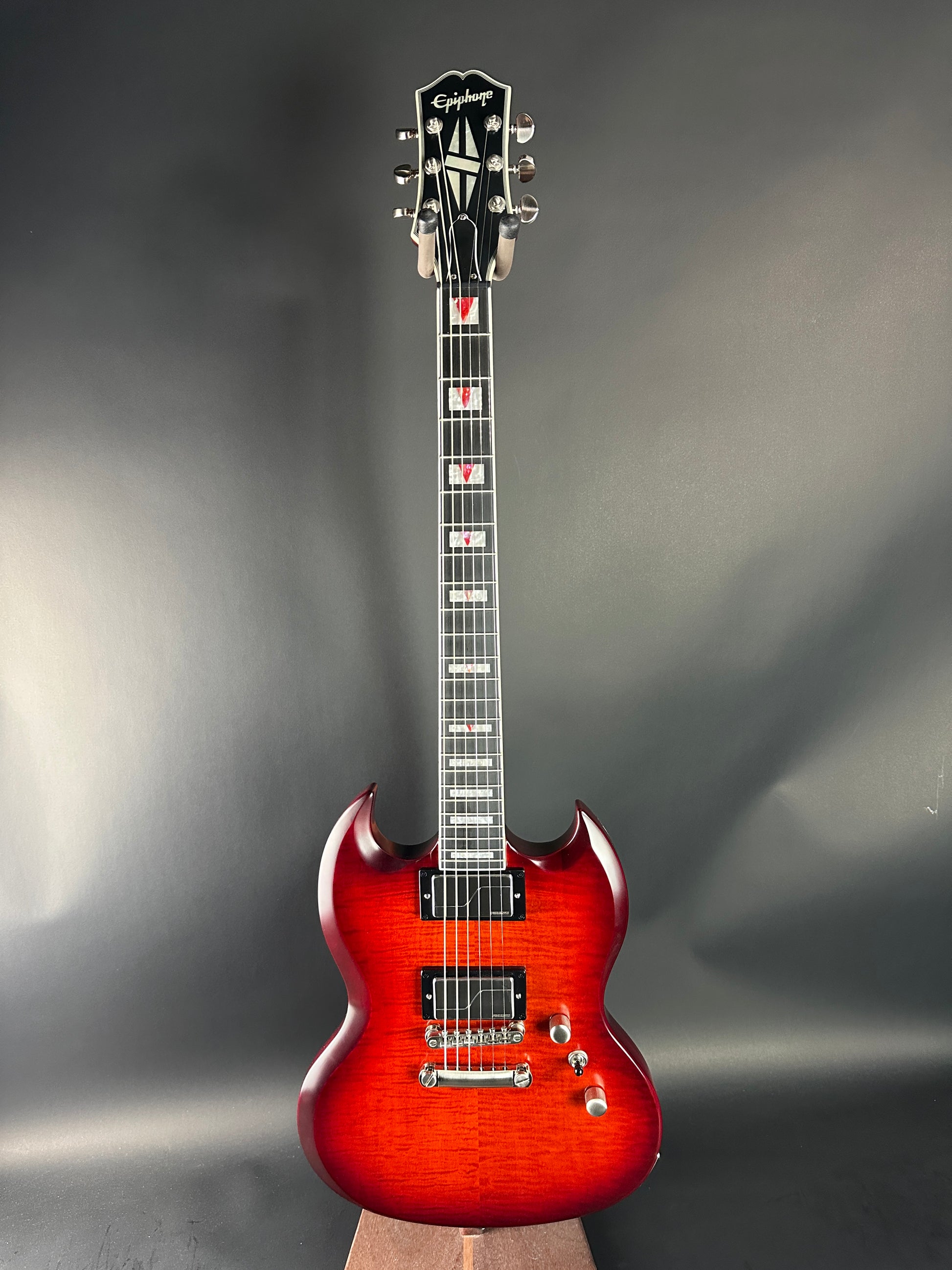 Electric guitar with a sunburst finish on a gray background