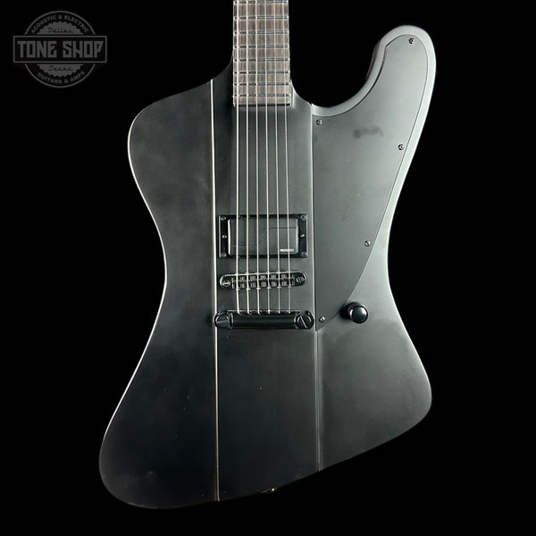 Black electric guitar on a black background with 'Tone Shop' logo.