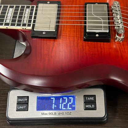Electric guitar on a digital scale displaying weight