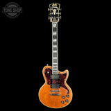 Electric guitar with a sunburst finish on a black background, featuring the 'Tone Shop' logo.