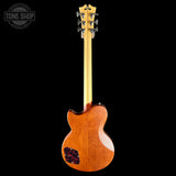 Back view of a wooden electric guitar with a visible brand logo in the corner.