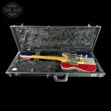 An electric guitar with a red, white, and blue livery design, displayed inside an open black hard case with a textured black interior. The brand logo 'TONE SHOP' is visible in the top-left corner.
