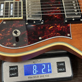Guitar on a digital scale displaying weight