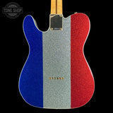 A Telecaster-style electric guitar body with a glitter finish painted in vertical blue, silver, and red stripes, shown against a black background. The neck is light wood, and a Tone Shop watermark is visible in the top left corner.