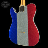 A custom glitter-finish electric guitar body with vertical stripes of royal blue, silver, and red, shown from the back against a black background.