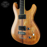 A natural wood electric guitar with black hardware, shown from a three-quarters angle against a solid black background. A 'TONE SHOP' watermark is visible in the top left corner.